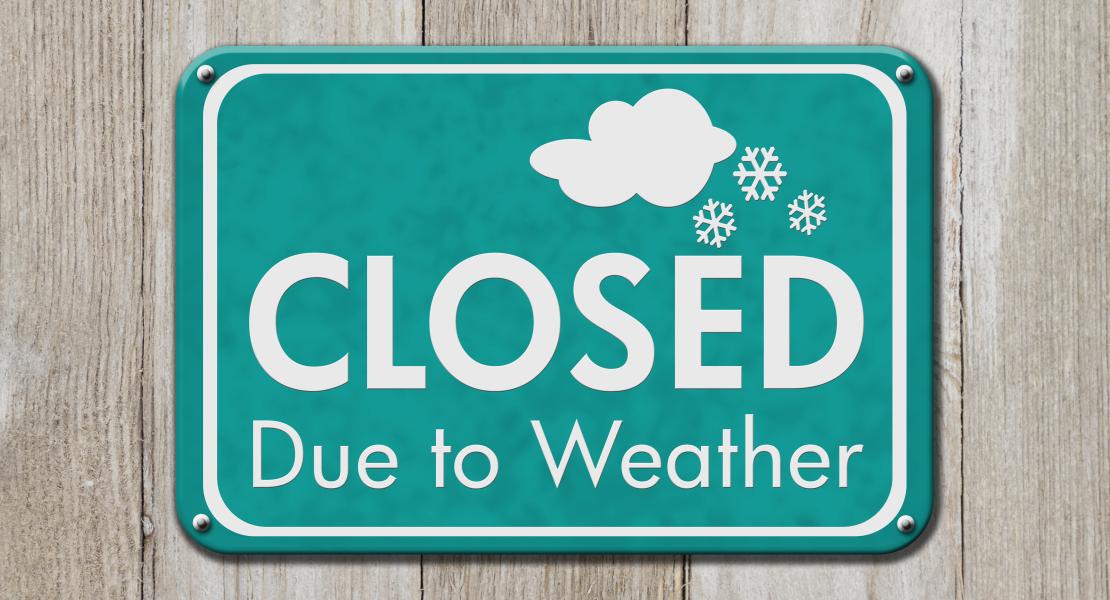 Sign with snow flakes that reads CLOSED due to weather