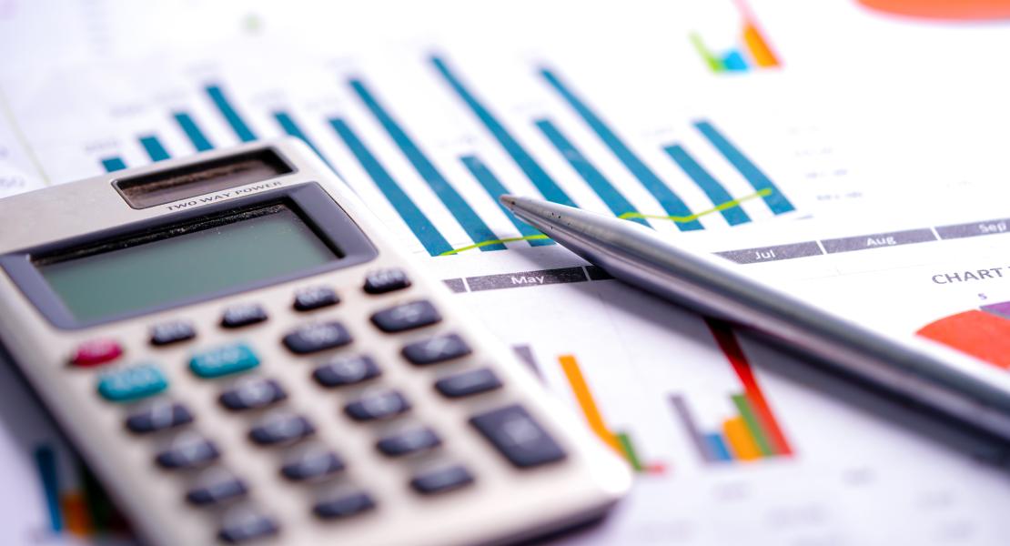 Calculator on desk next to papers