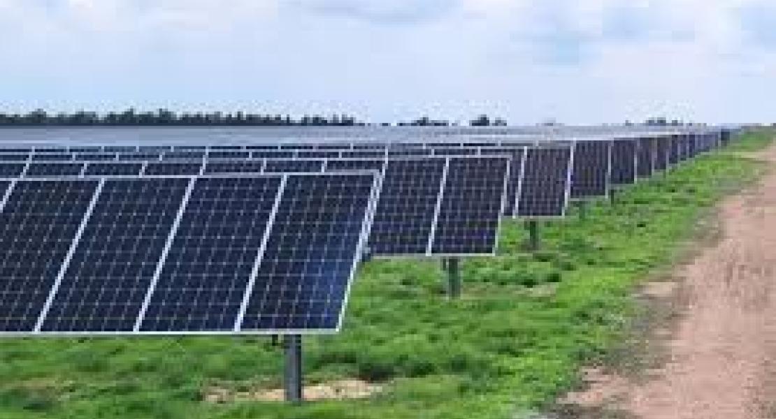 Solar Panels aligned next to a dirt access road